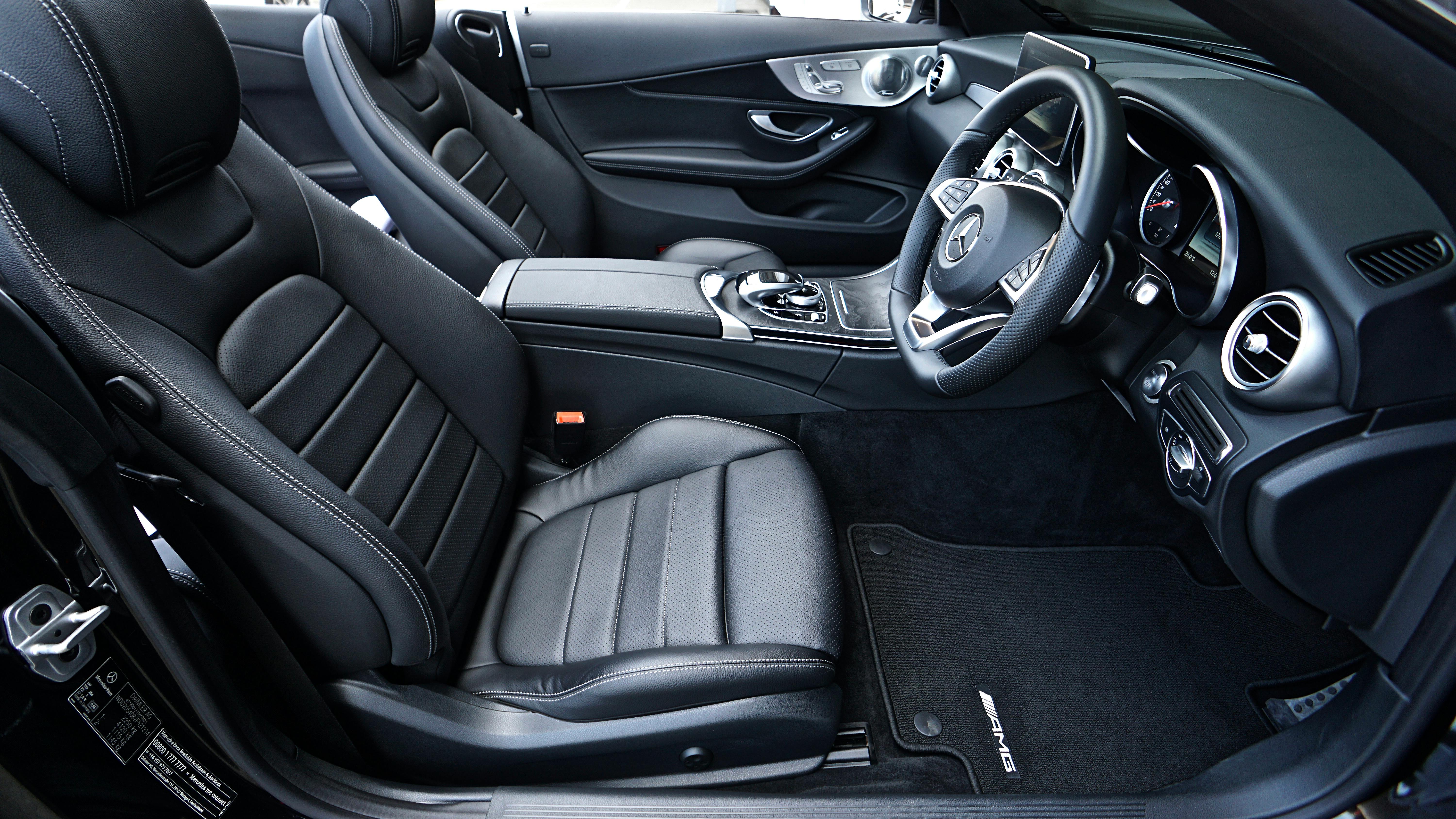 The interior of a car, steering wheel and front seats