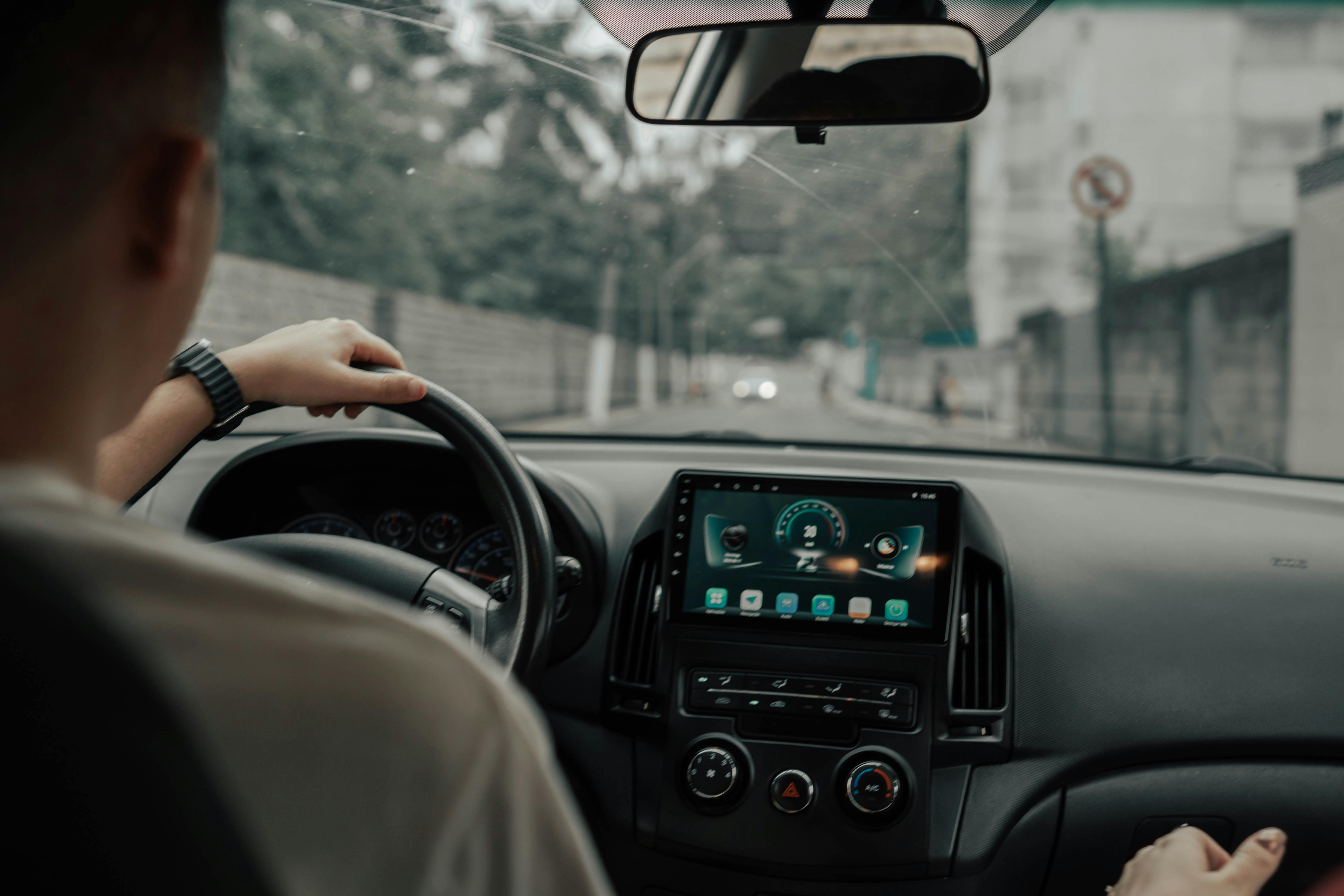 A driver's view of the dashboard while driving through town