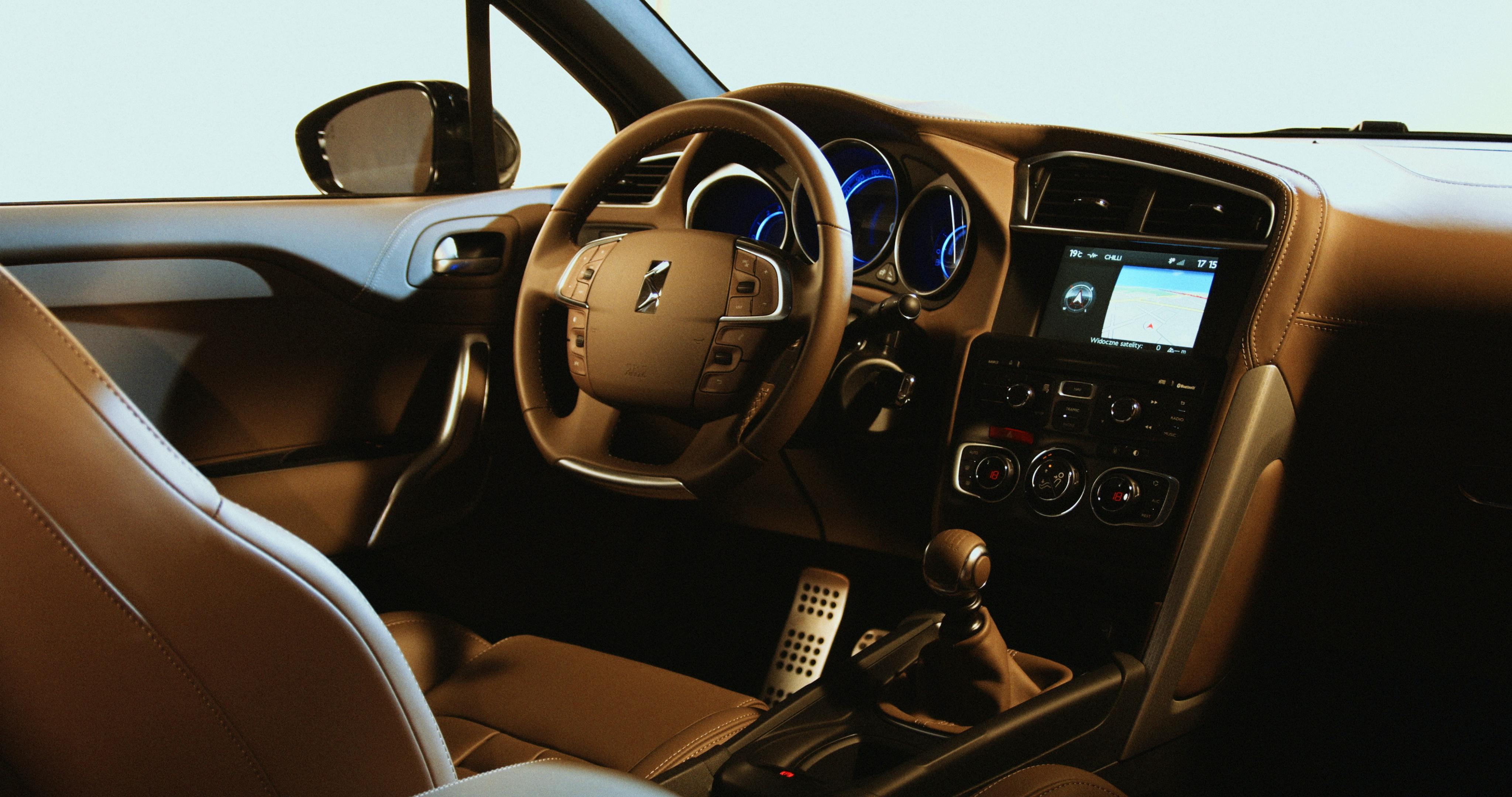 Tan leather car interior showing the steering wheel and dashboard