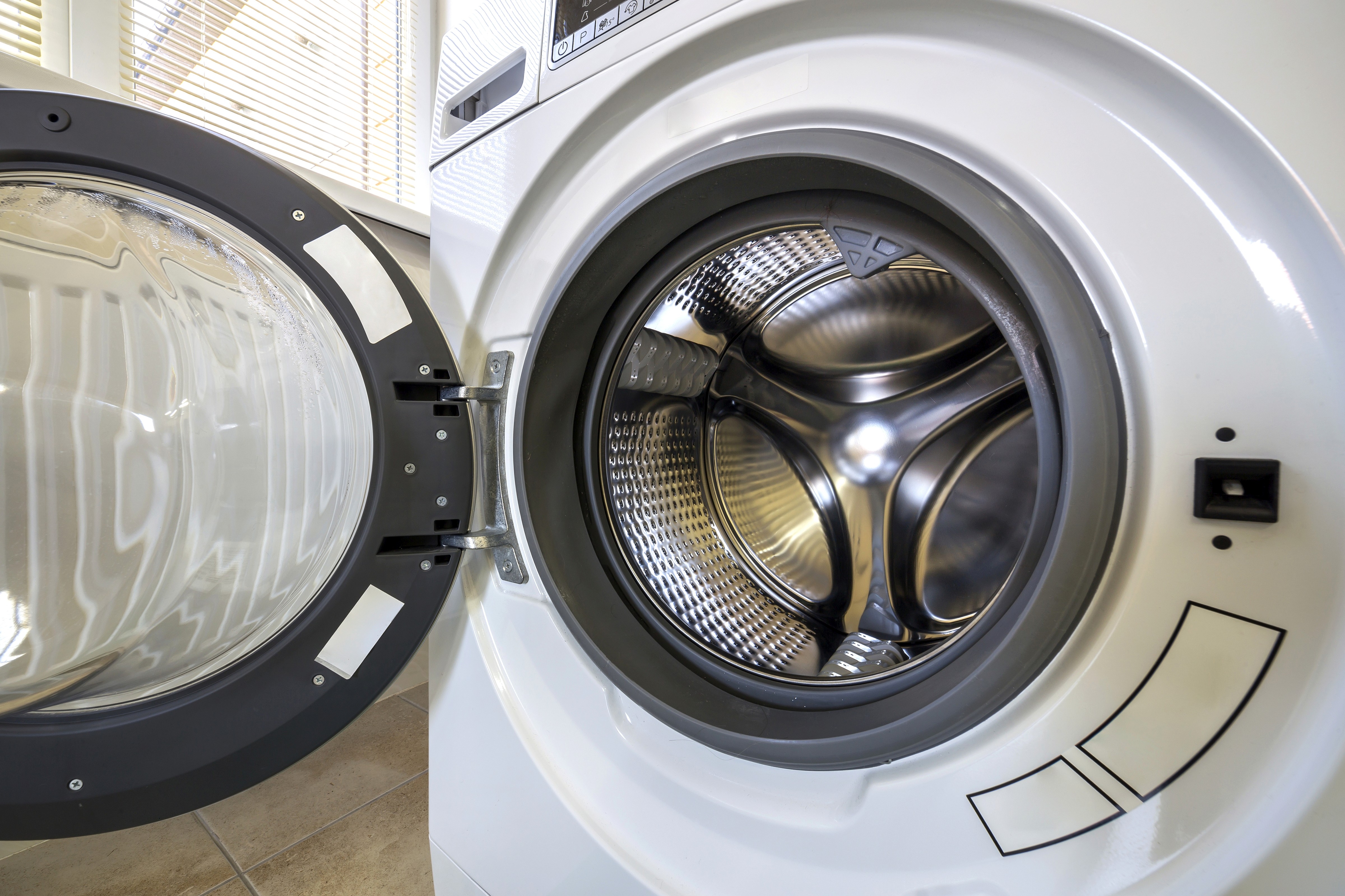 An open washing machine at home