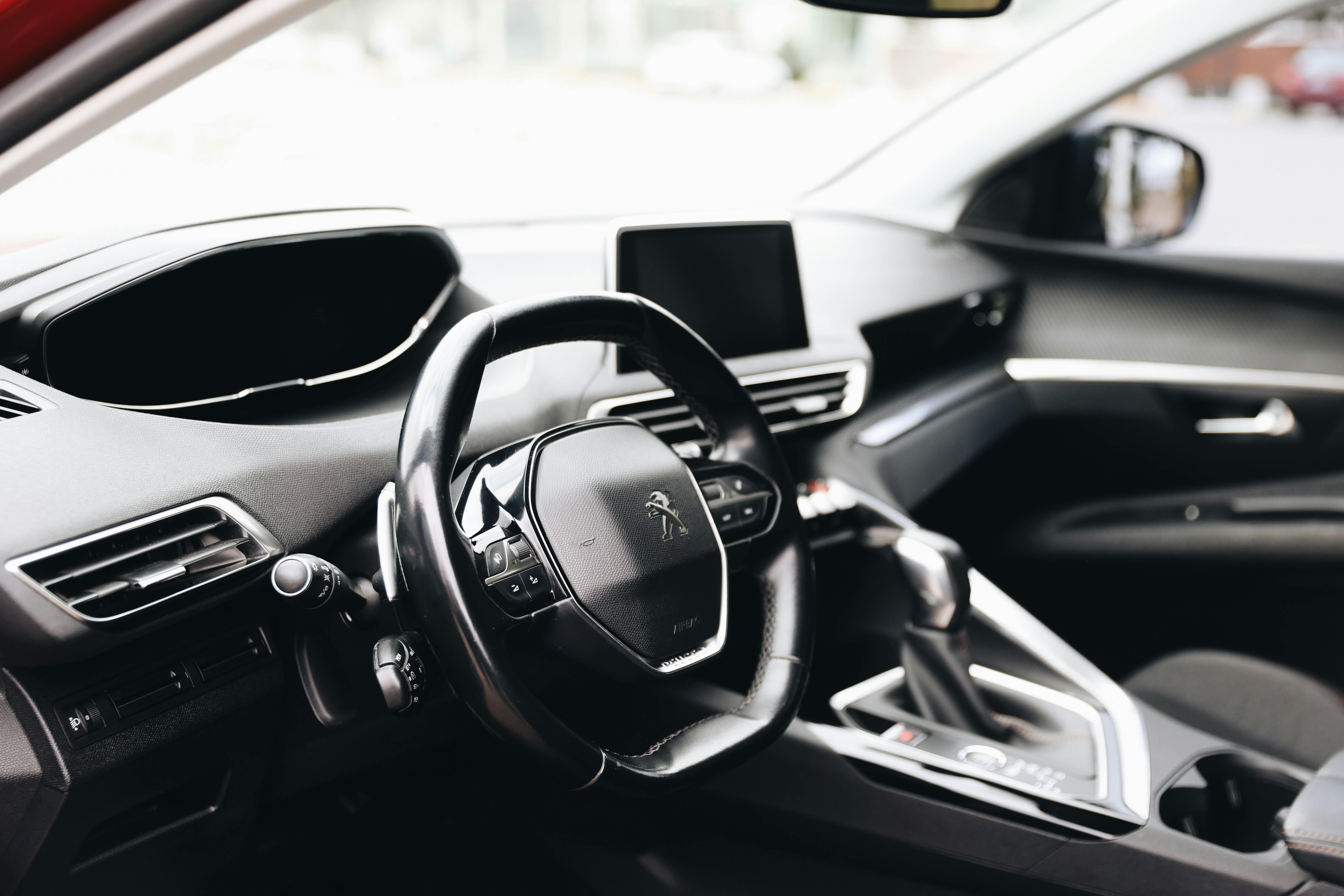 The steering wheel and dashboard of a parked car