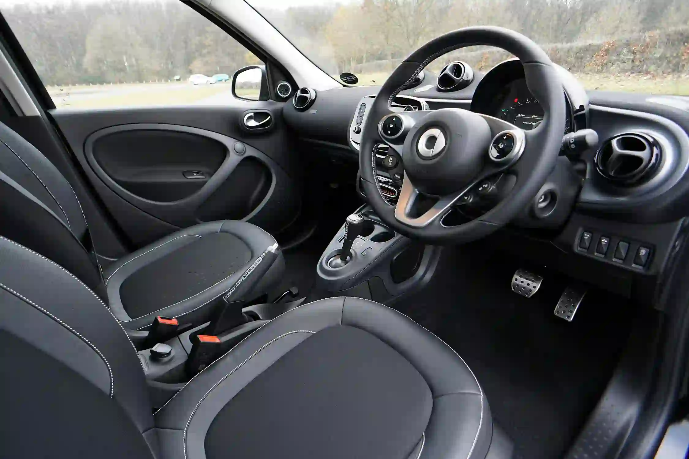 The driver’s seat and steering wheel of a car used for work