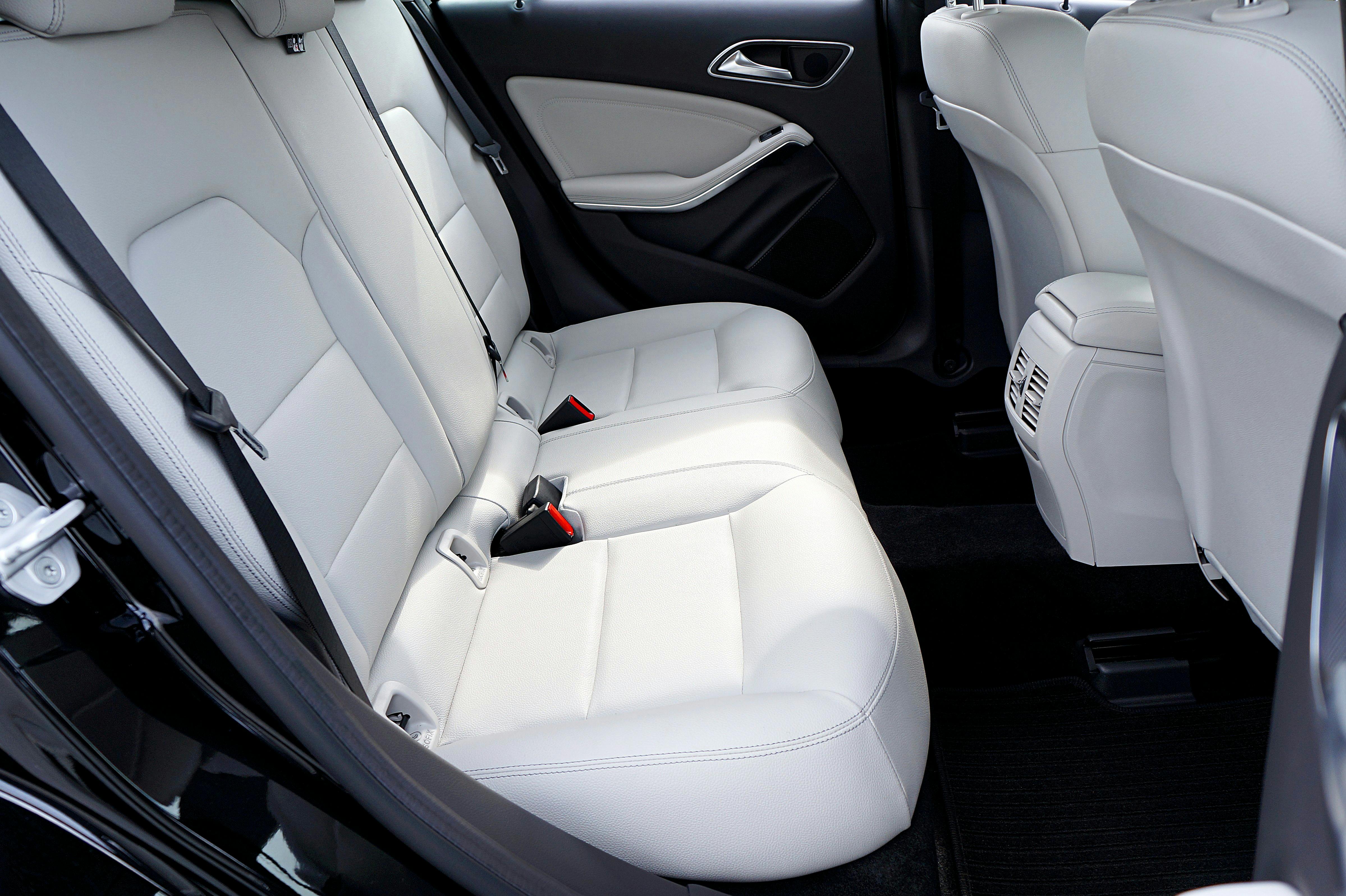 Rear seats of a car with pale leather upholstery