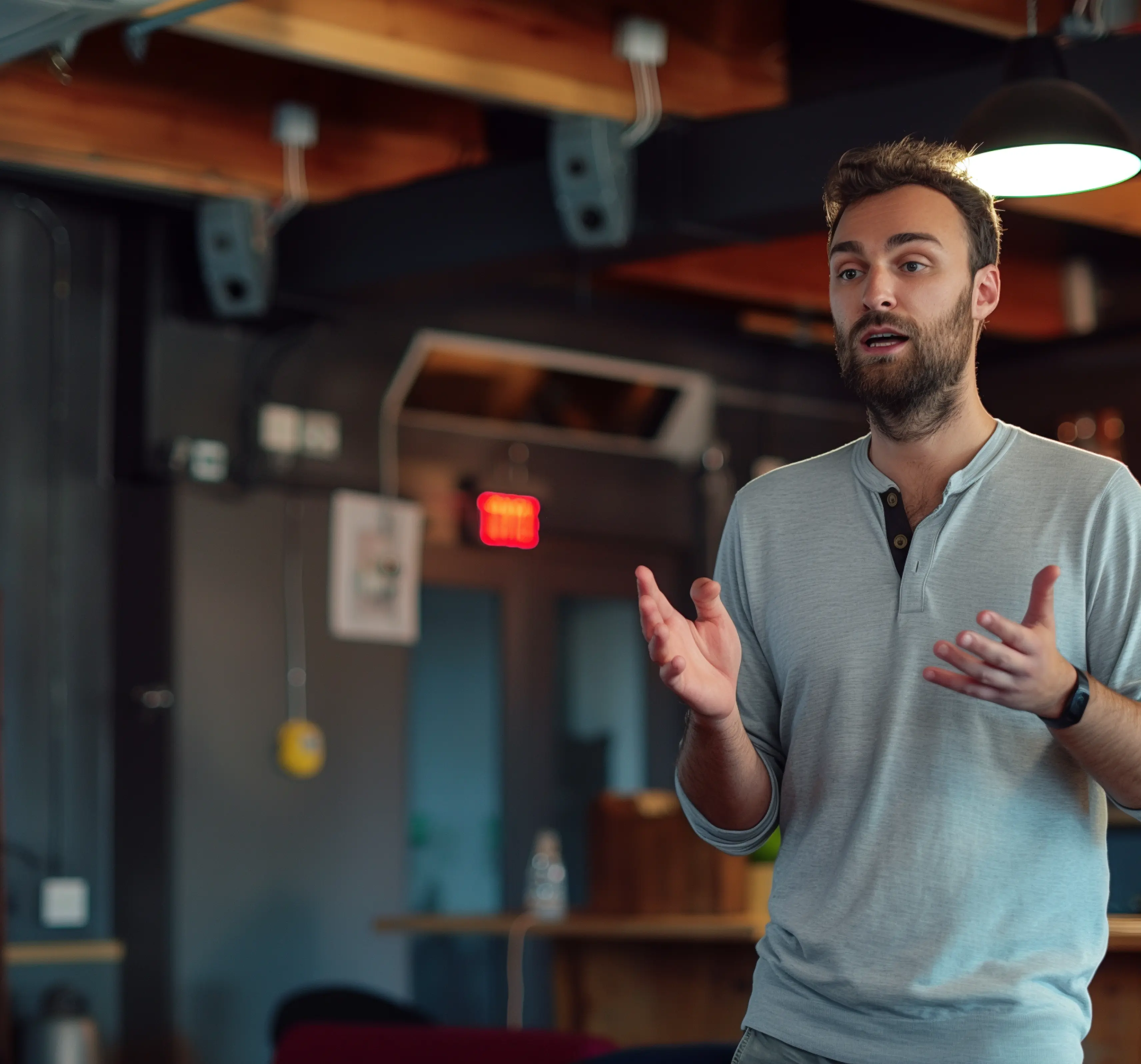 Person talking and gesturing in a relaxed office space
